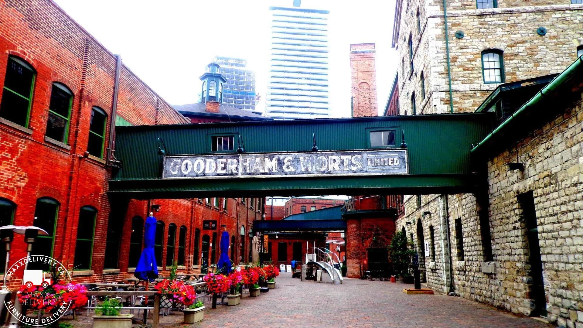 A bridge between two brick buildings with the word cooper on it