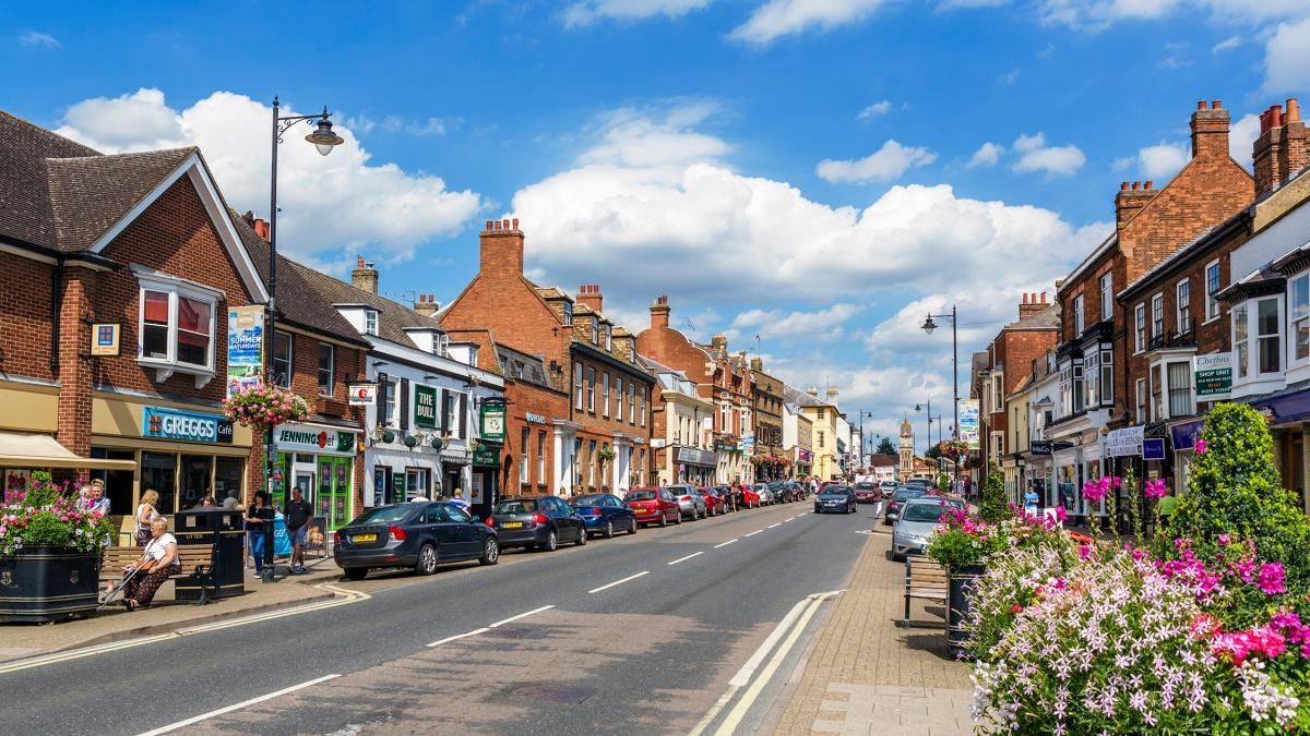 A row of brick buildings along a street in a small town.