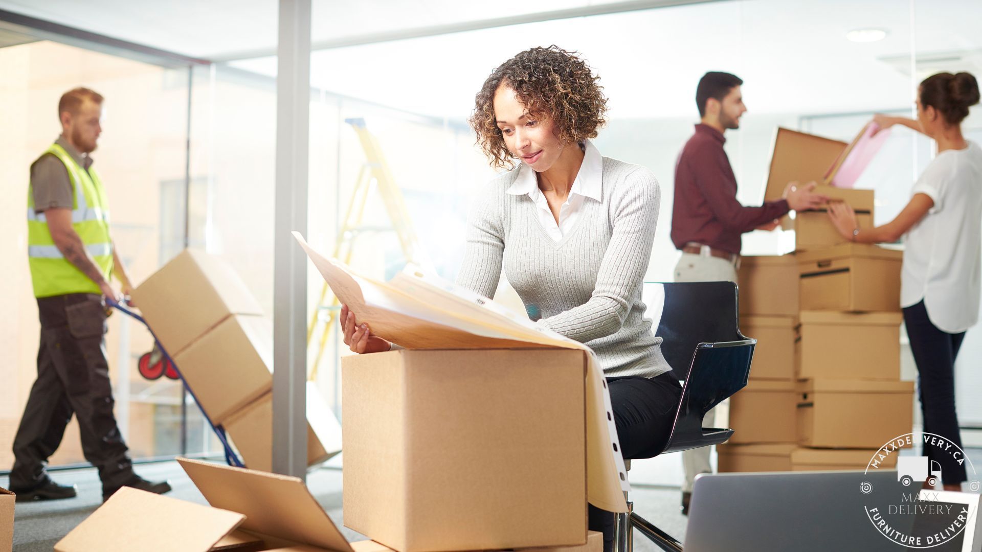 A group of people are moving into a new office