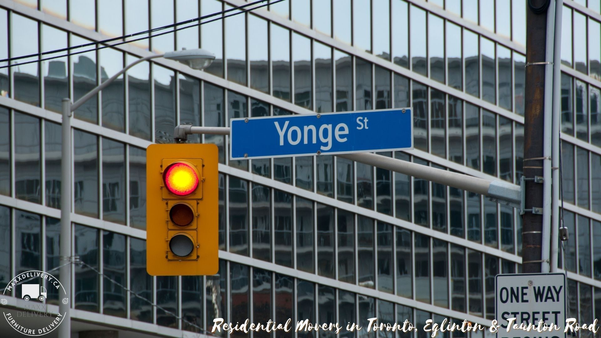 Yonge street sign above a traffic light in front of a building