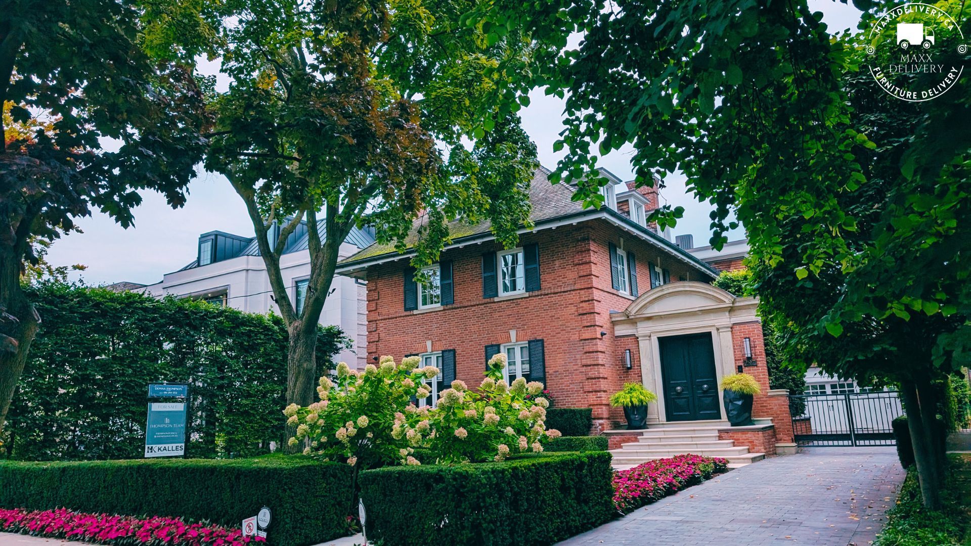 A large brick house with a driveway leading to it