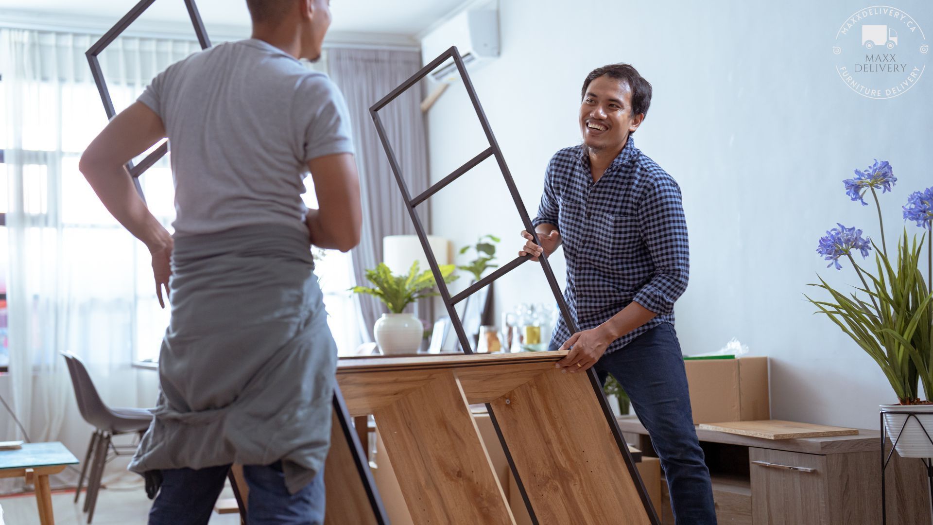 Two men are working on a wooden table in a living room - Top Furniture Movers