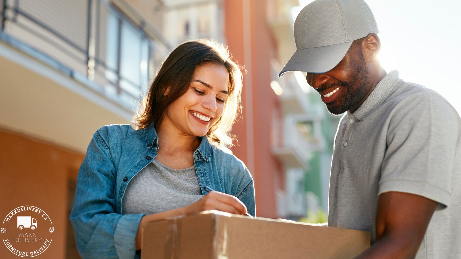 A man is delivering a package to a woman who is smiling