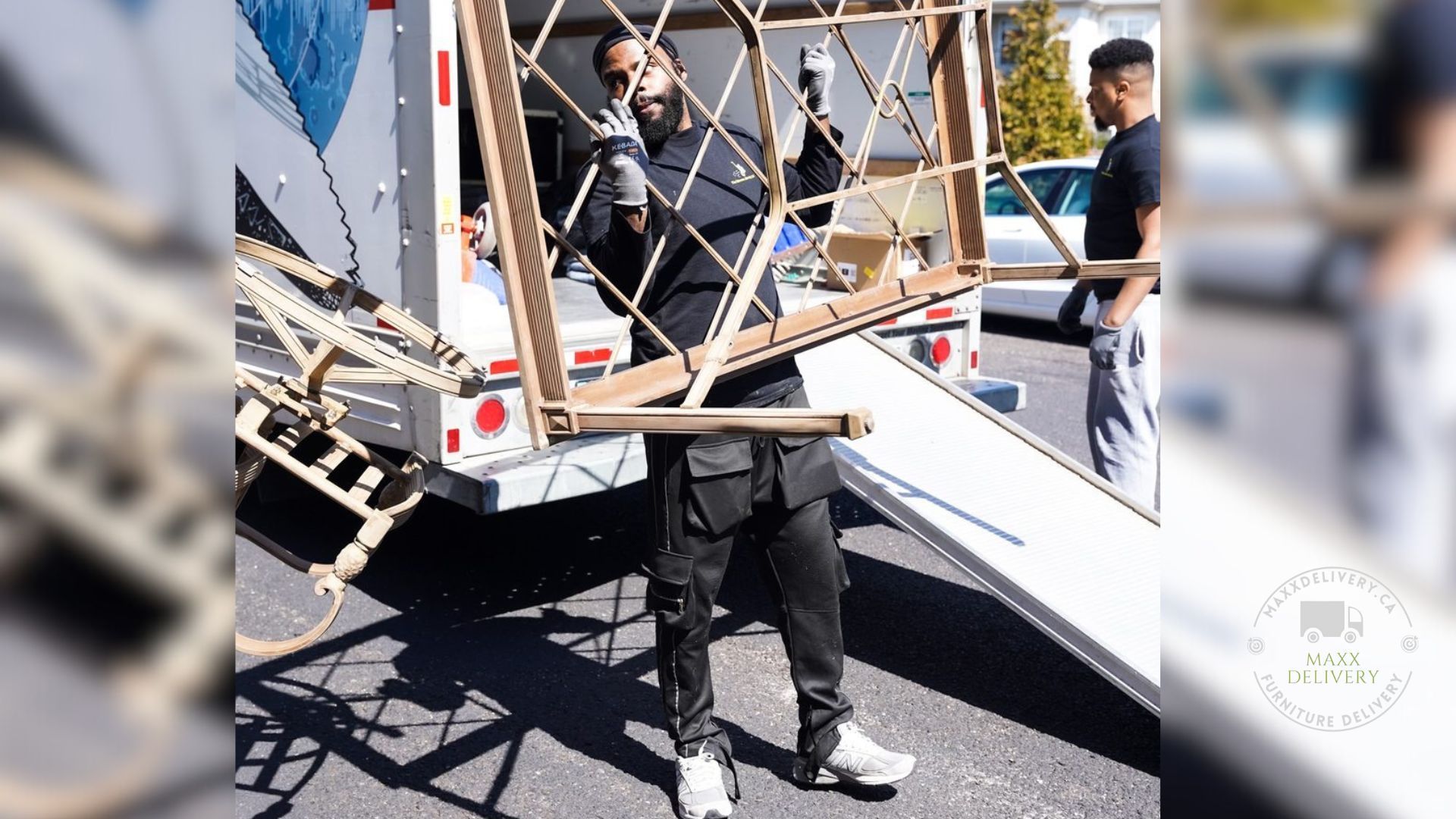 A man is holding a piece of wood in front of a truck