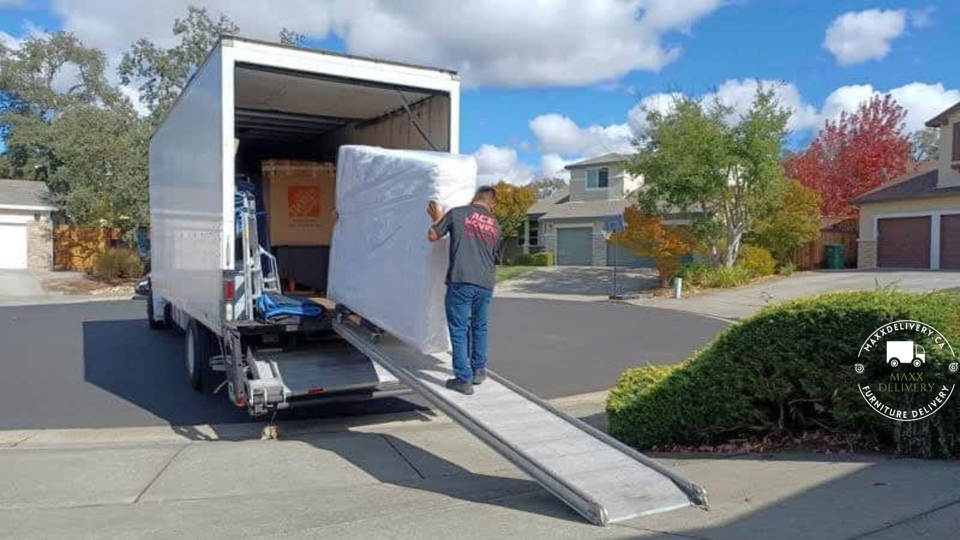 A man is loading a mattress into a moving truck.