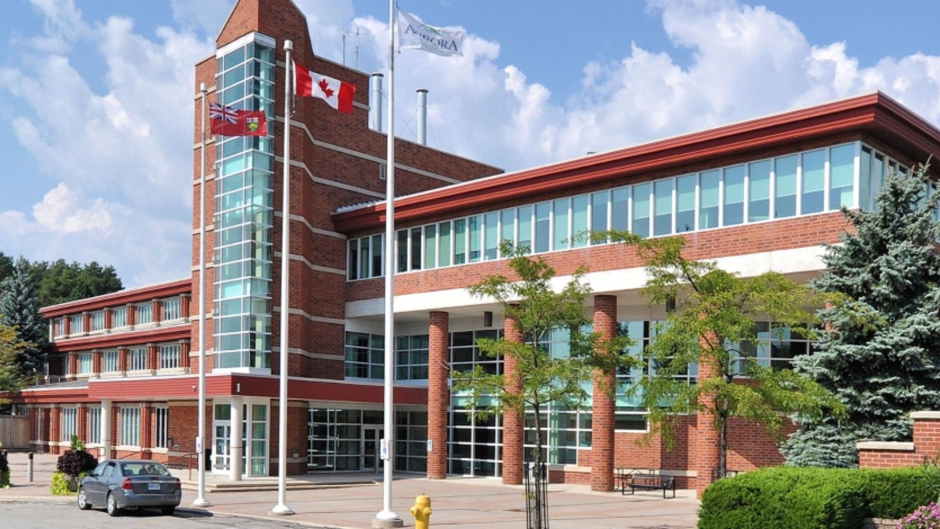 A large brick building with a canadian flag on top