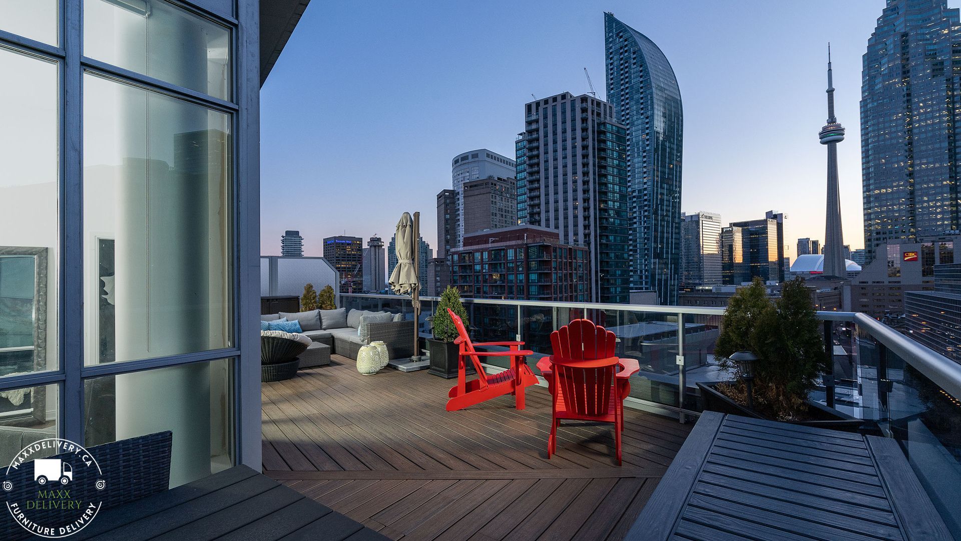 Two red chairs on a balcony overlooking Toronto - condo movers toronto