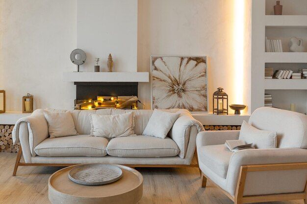 A living room with a couch , chair , coffee table and fireplace.