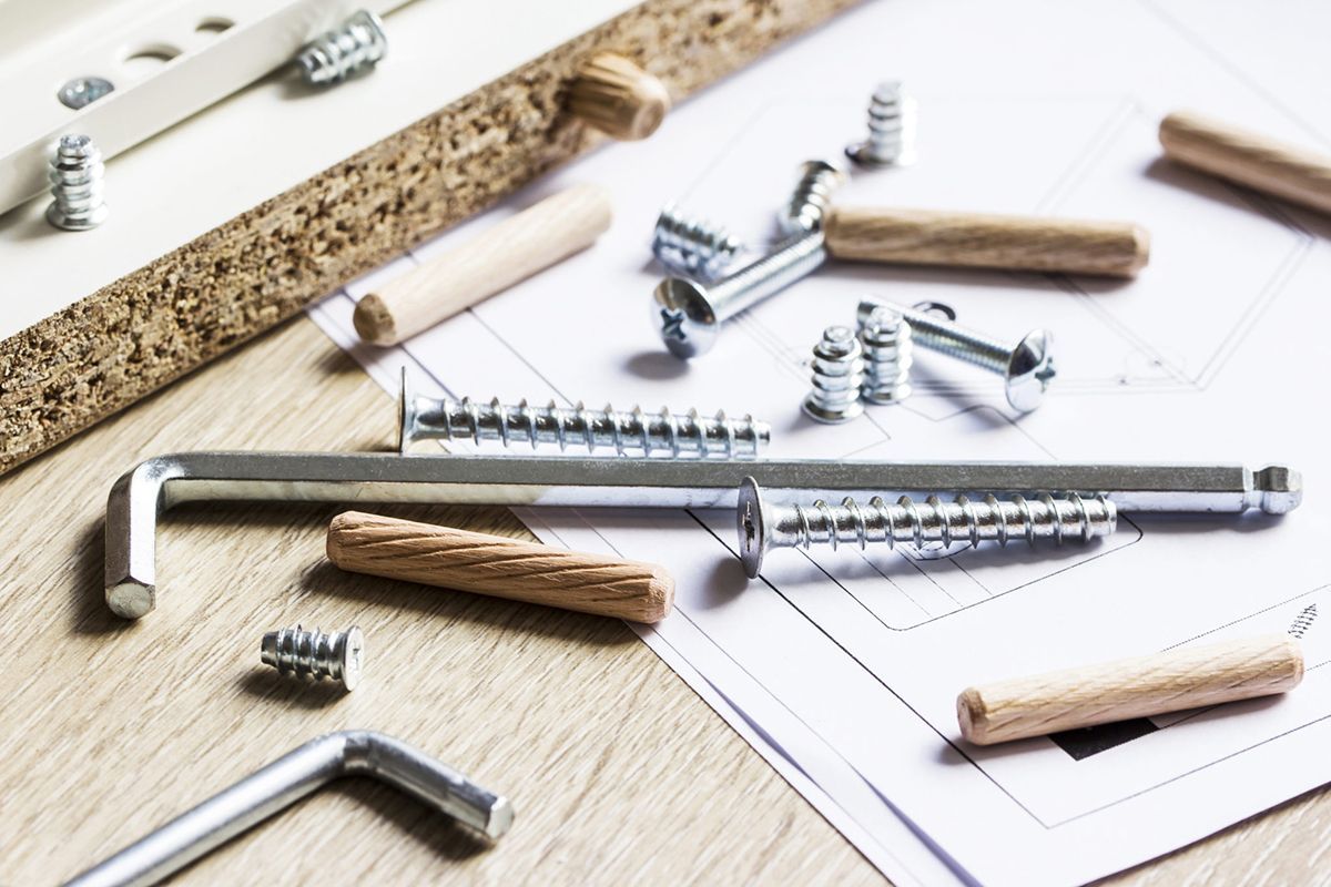 A bunch of screws and wooden dowels on a table