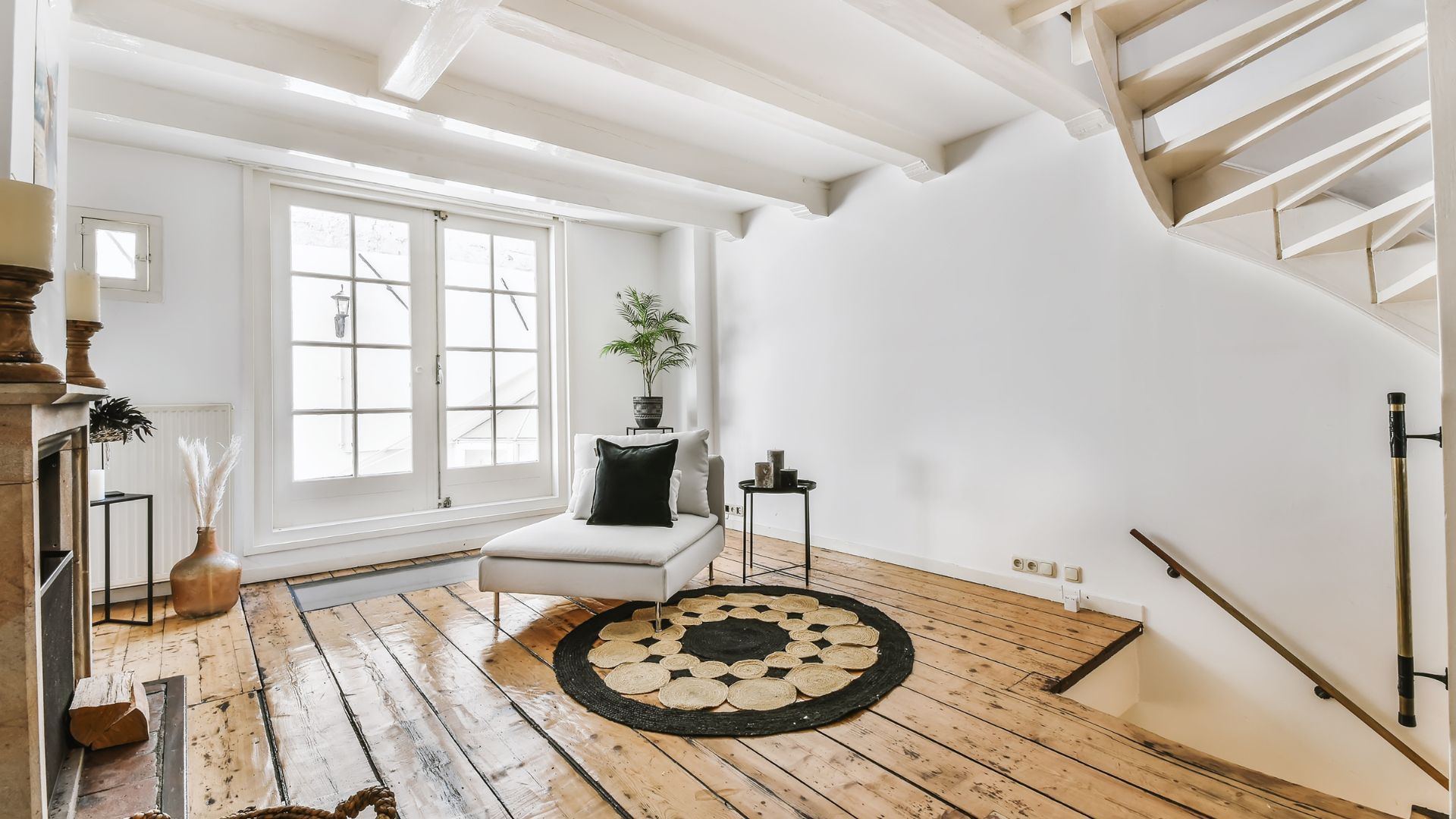 A living room with a chair and stairs in the background - moving on a budget