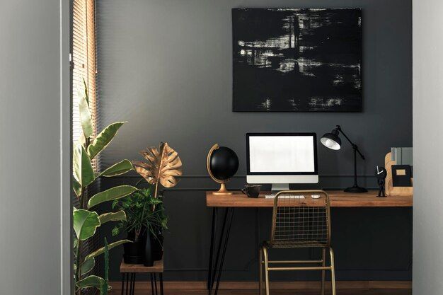 A home office with a computer on a desk and a chair.