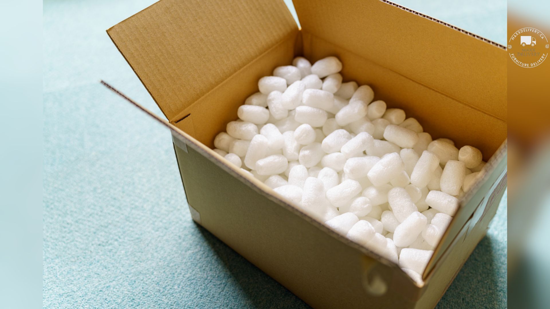 A cardboard box filled with white packing peanuts