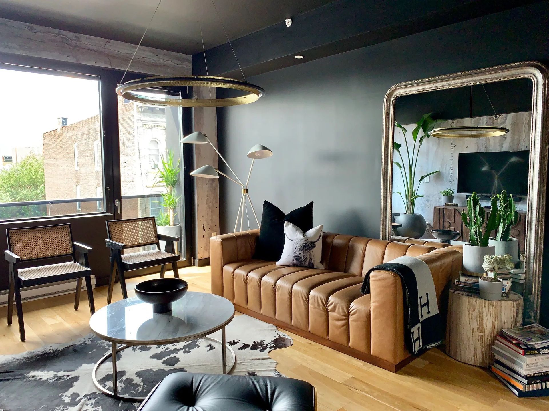 A living room with a couch and a large mirror