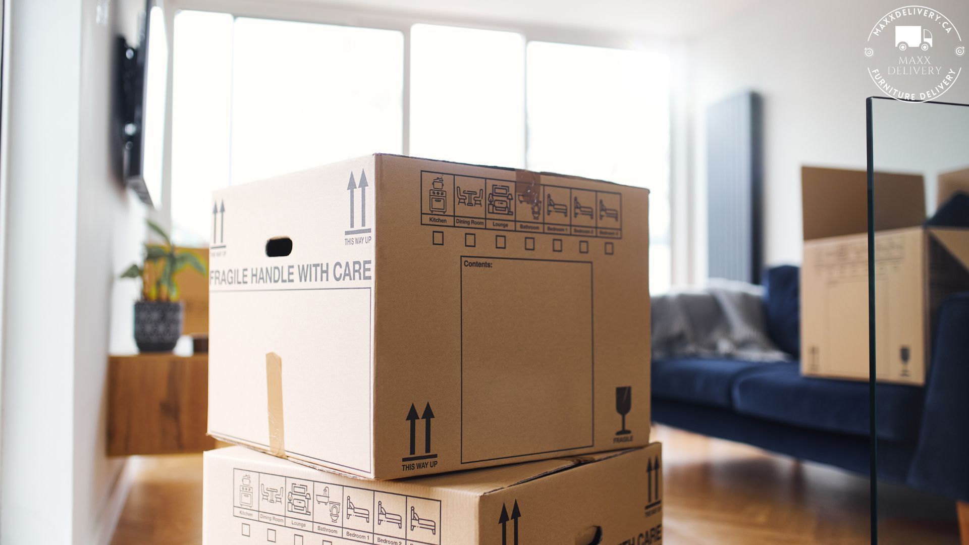 A stack of cardboard boxes in a living room says fragile at home