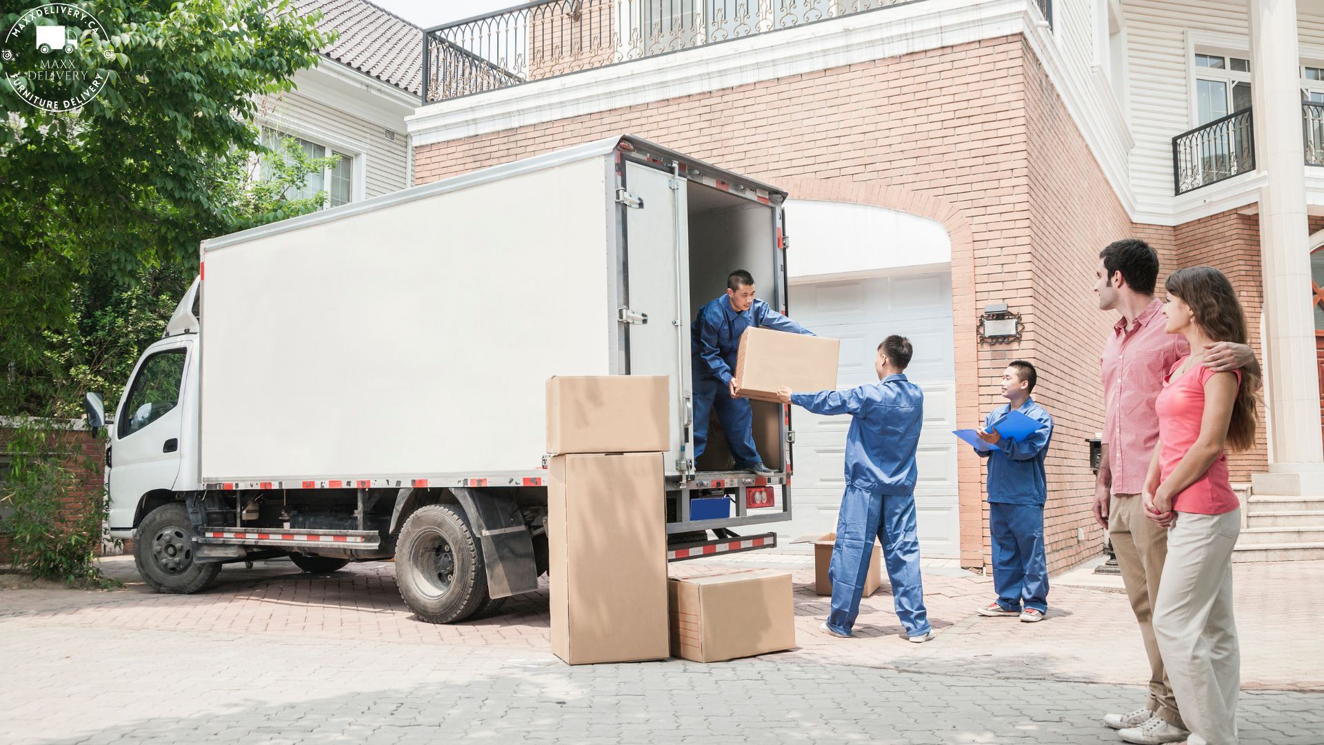 A group of people are standing in front of a moving truck