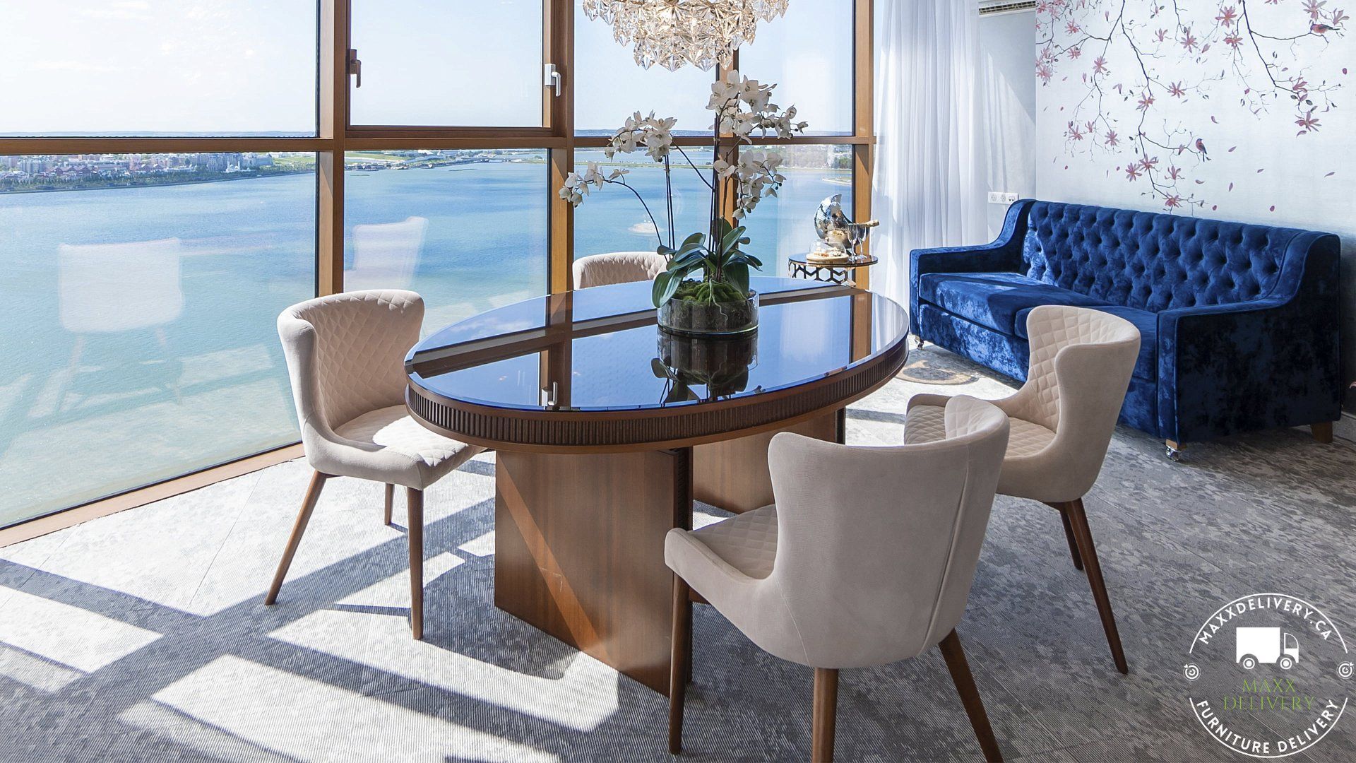 A dining room with a table and chairs and a blue couch