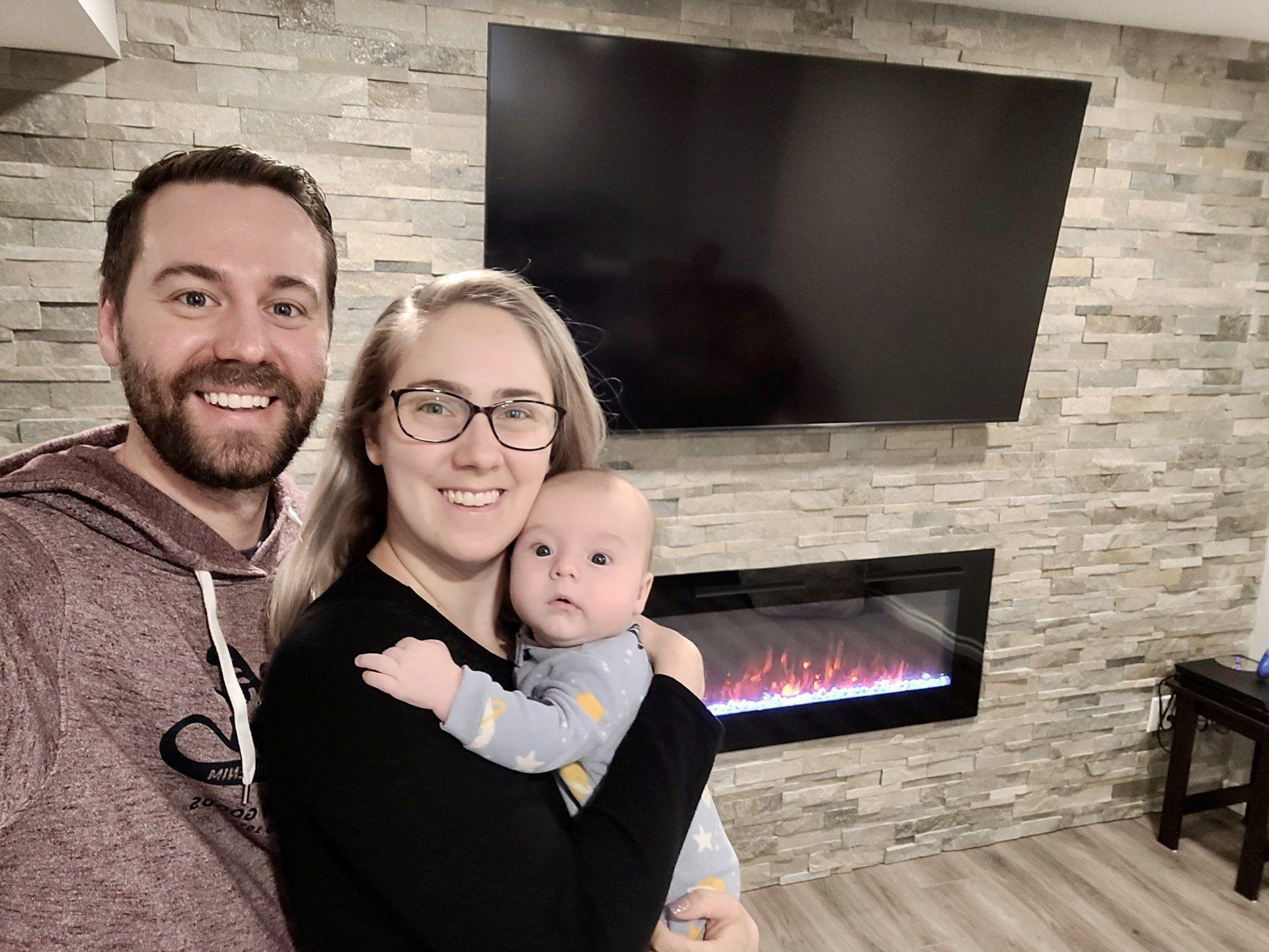 Eddie, Jennifer and baby in their newly renovated basement where Nichols Electric did the electrical