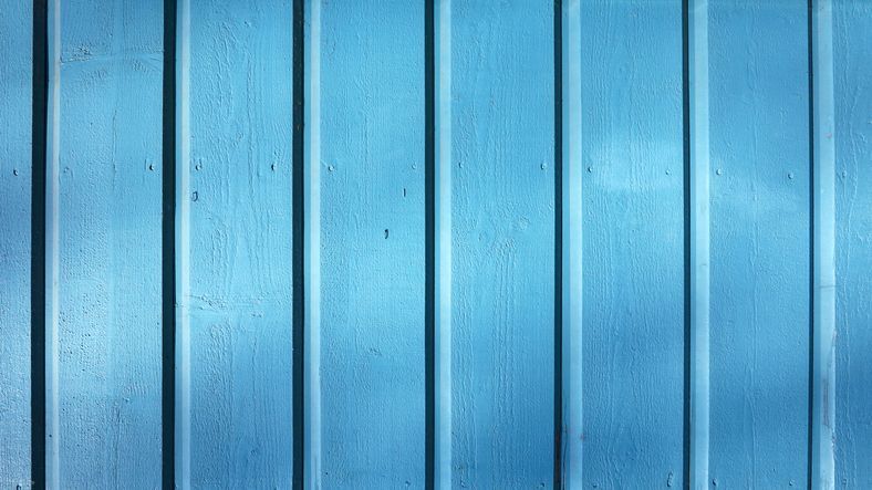 Looking up at the roof of a house with a blue sky in the background