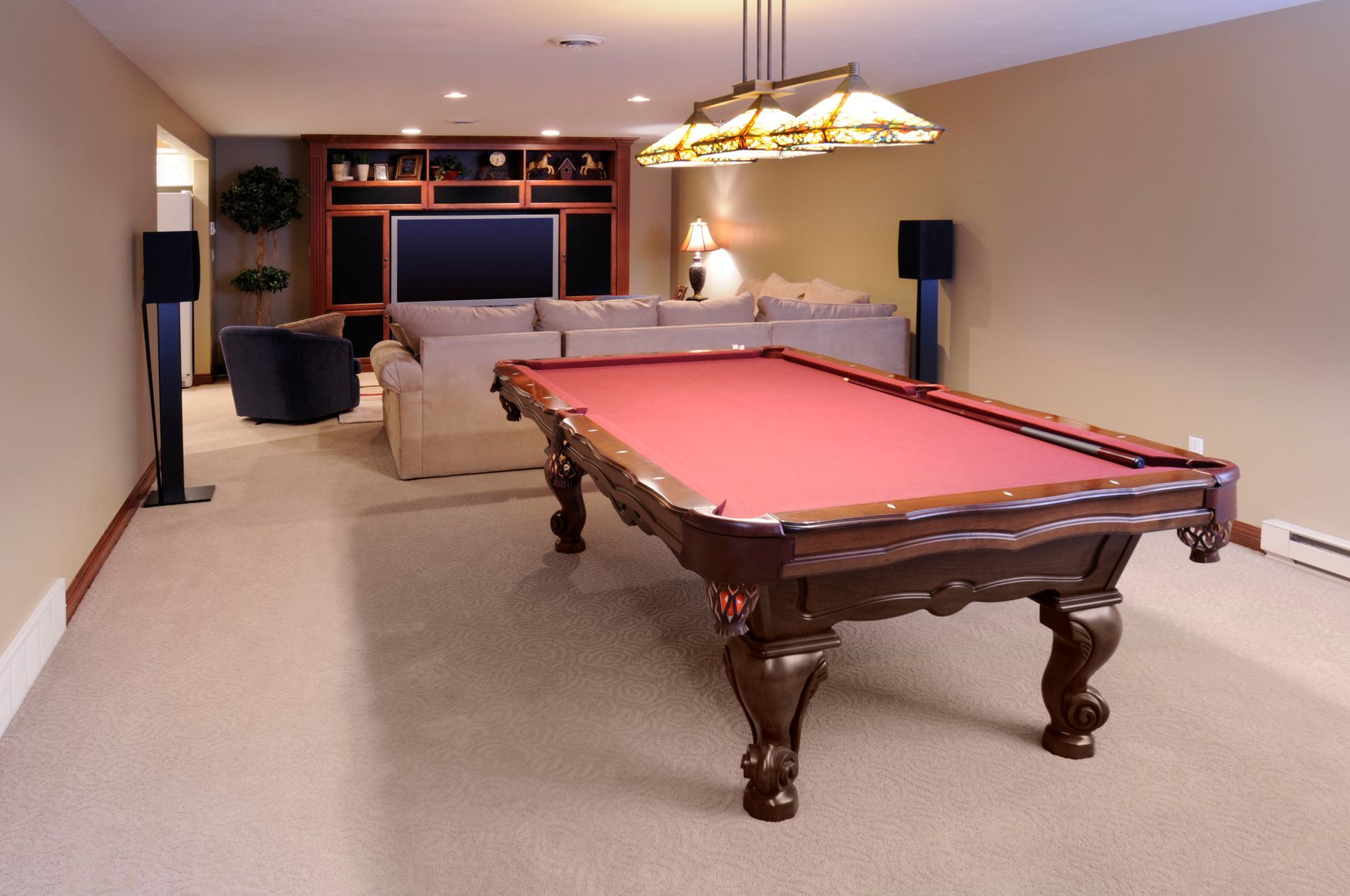 A pool table is in the middle of a living room