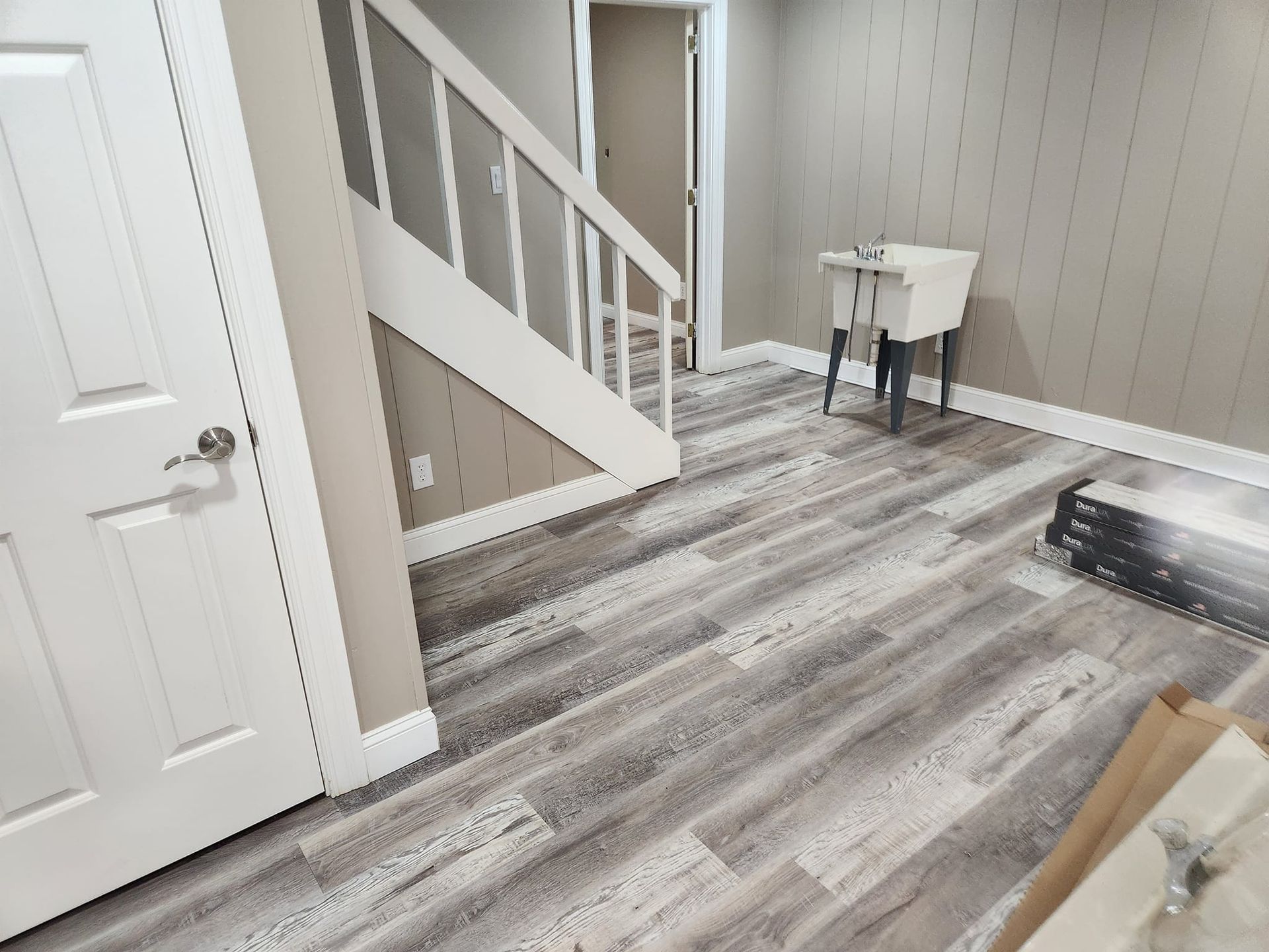 A living room , dining room , and kitchen in a large apartment.