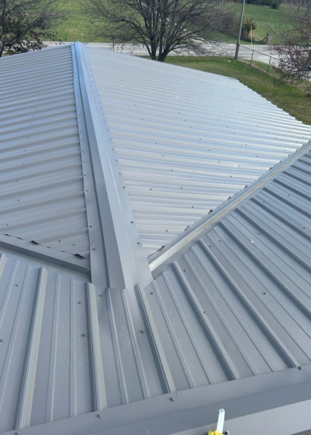 The roof of a brick building has a metal roof