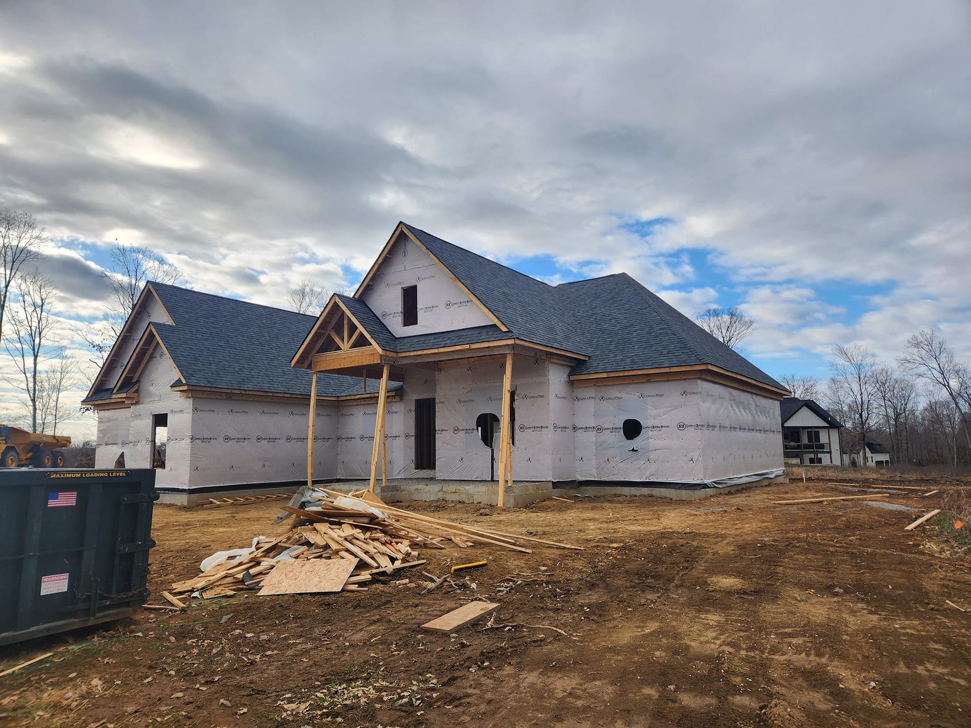 A house with a window on the roof and a blue sky in the background.