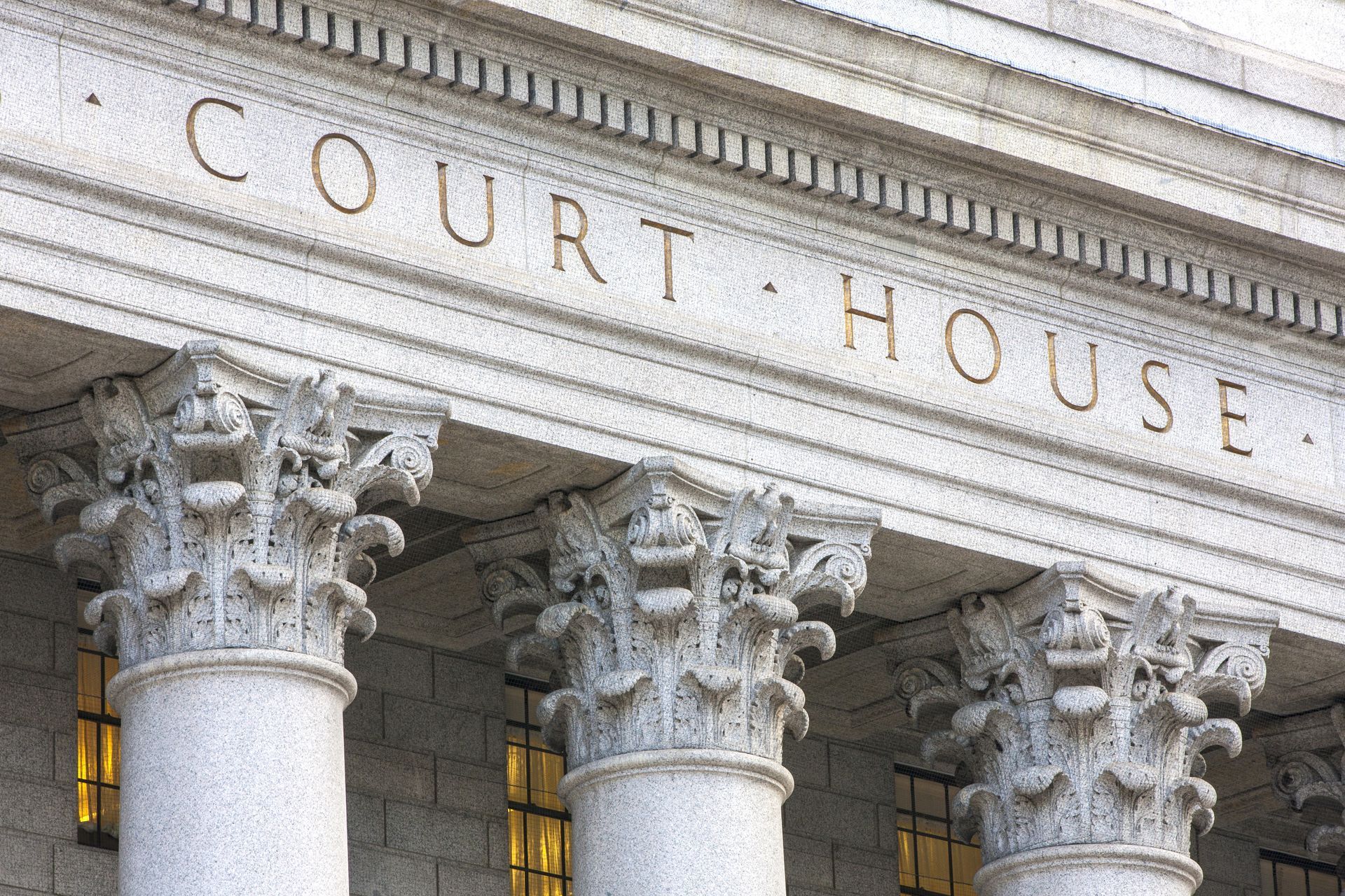 The front of a courthouse with columns and the words court house written on it