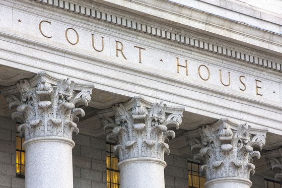 The front of a courthouse with columns and the words court house written on it