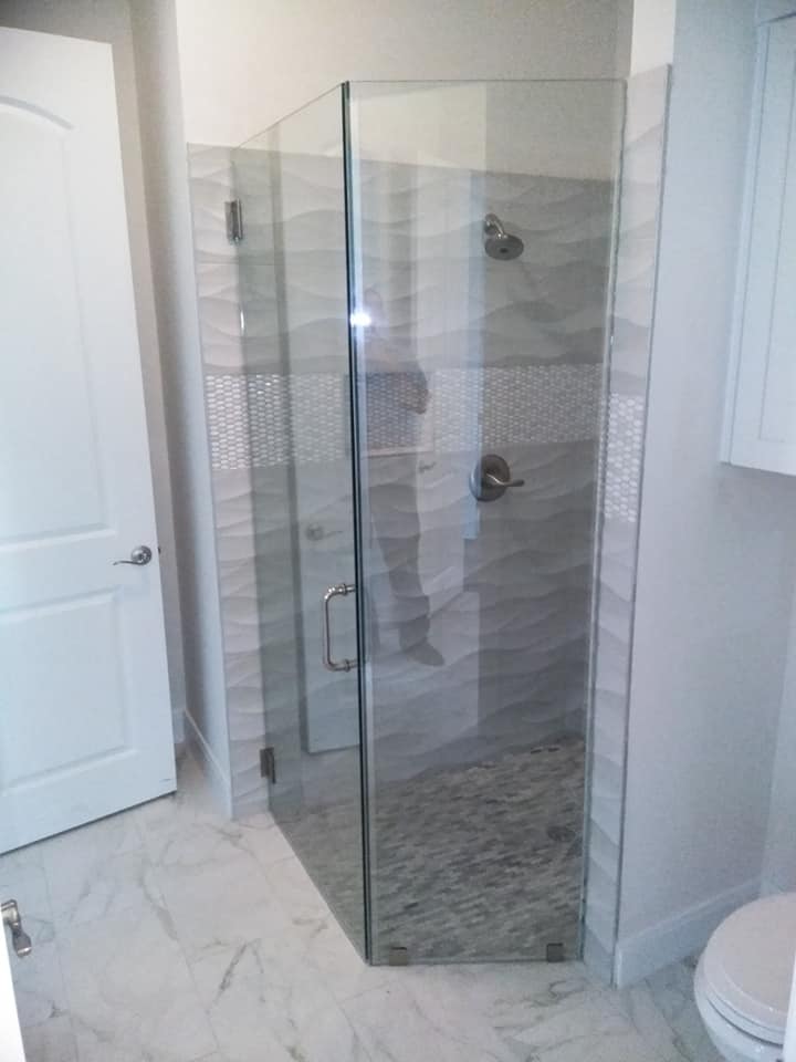 A bathroom with a walk in shower and a toilet.