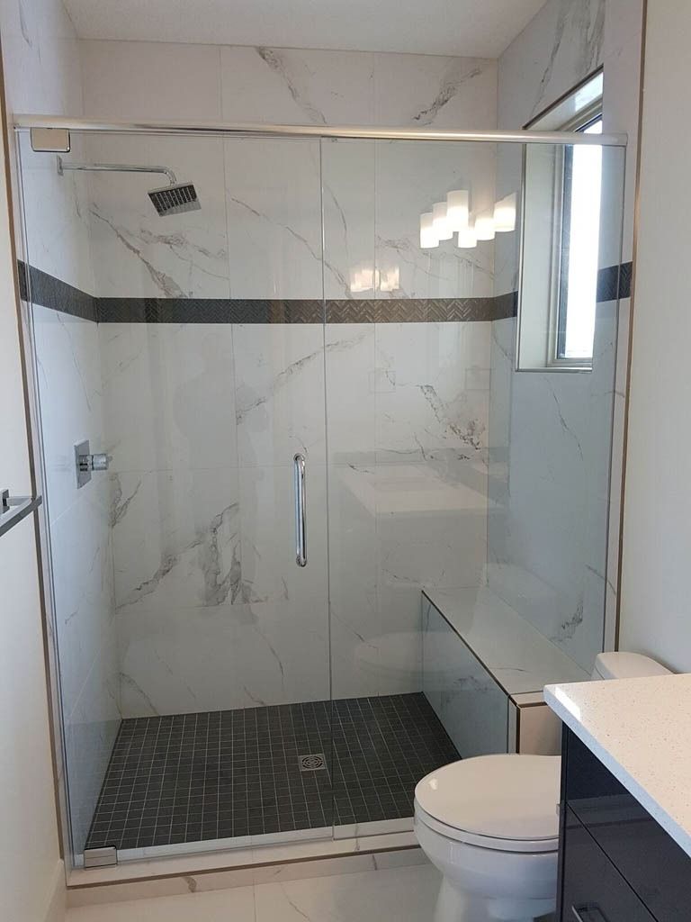 A bathroom with a walk in shower and a toilet