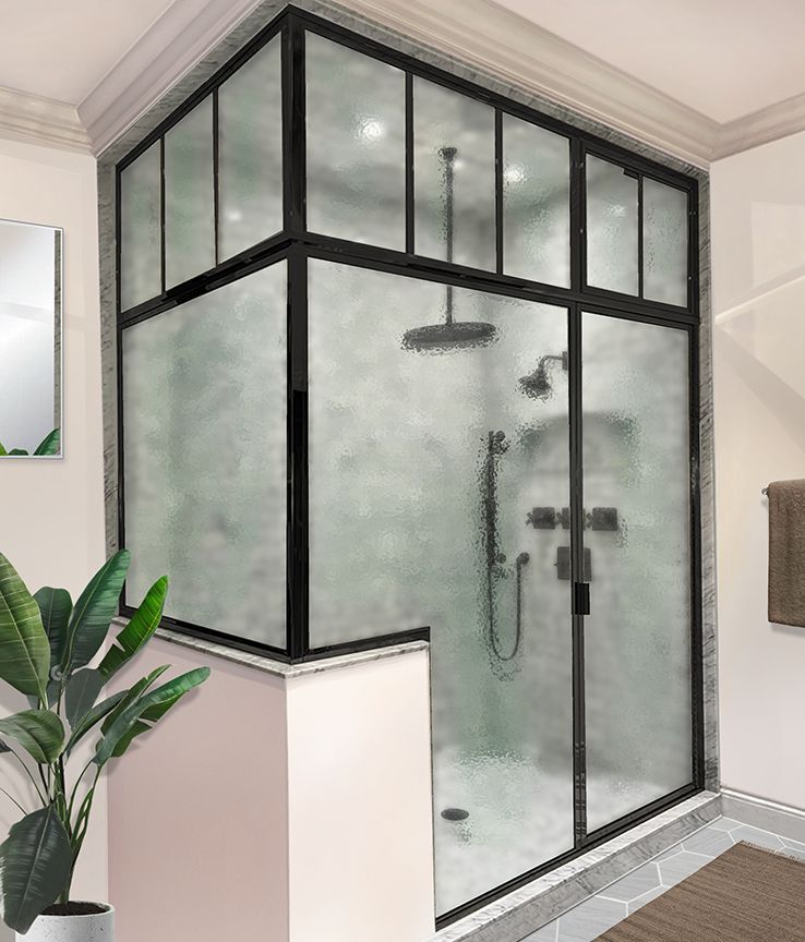 A bathroom with a sliding glass shower door and a plant.