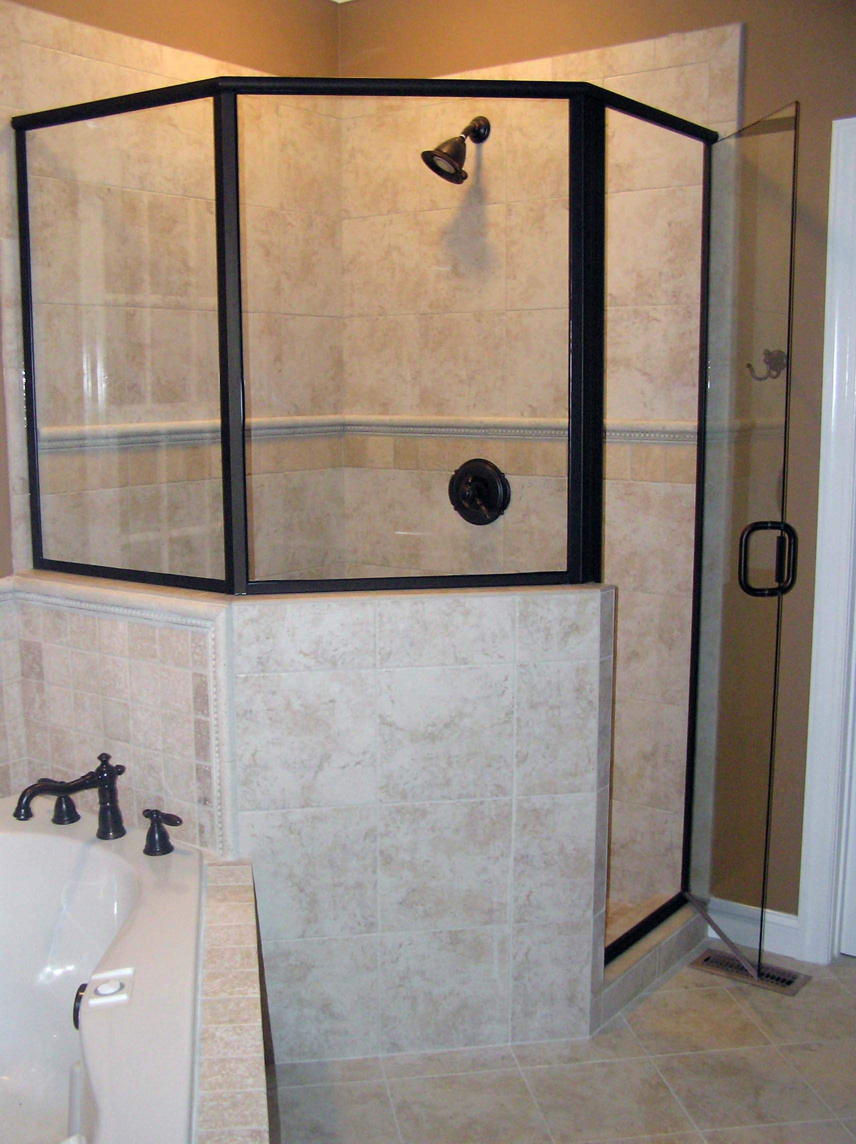 A bathroom with a walk in shower and a bathtub