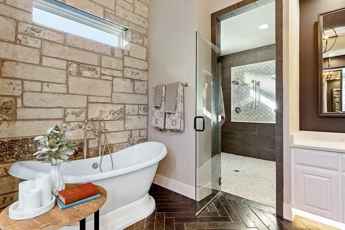 A bathroom with a bathtub and a walk in shower.