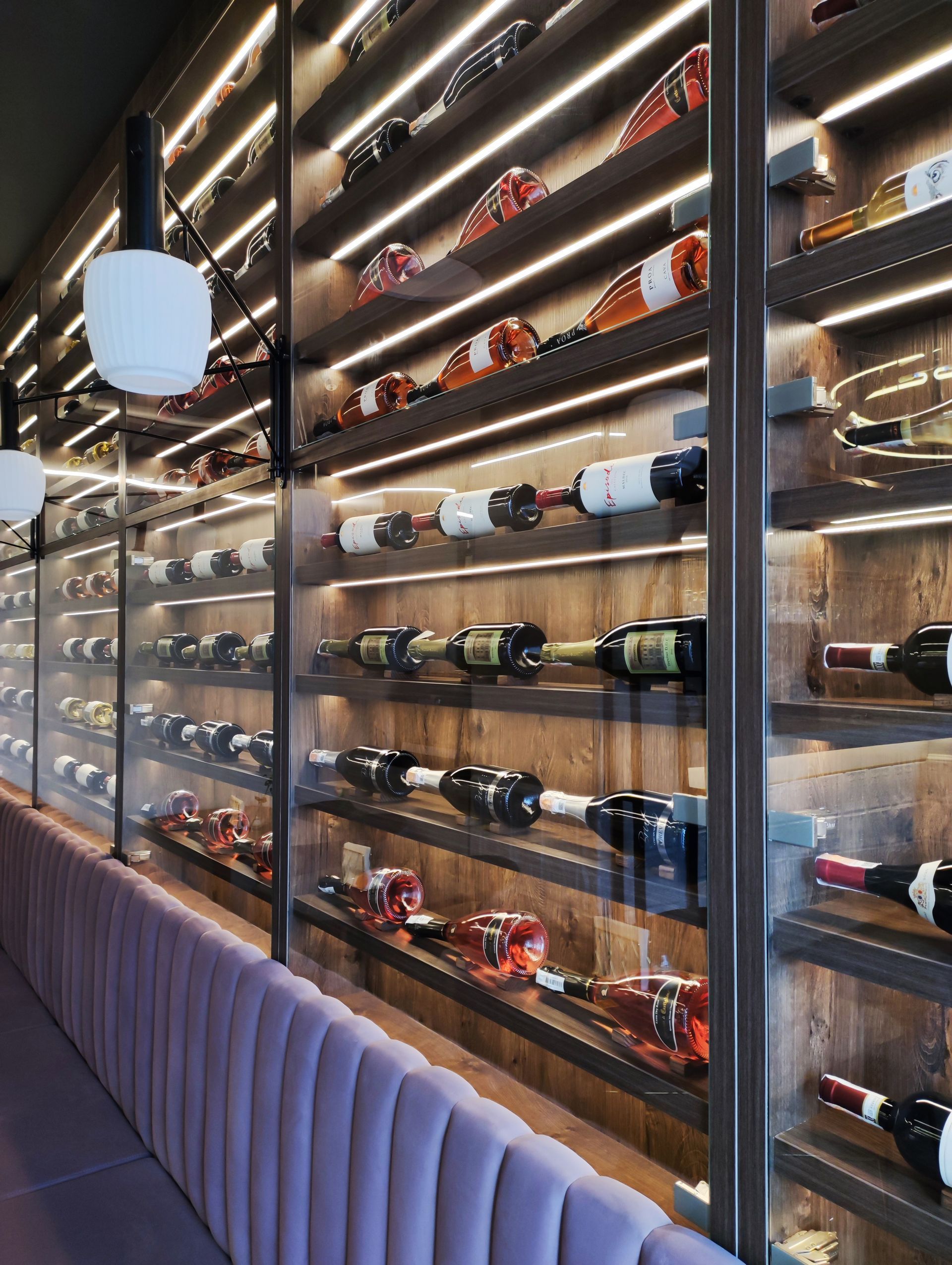 A row of shelves filled with bottles of wine