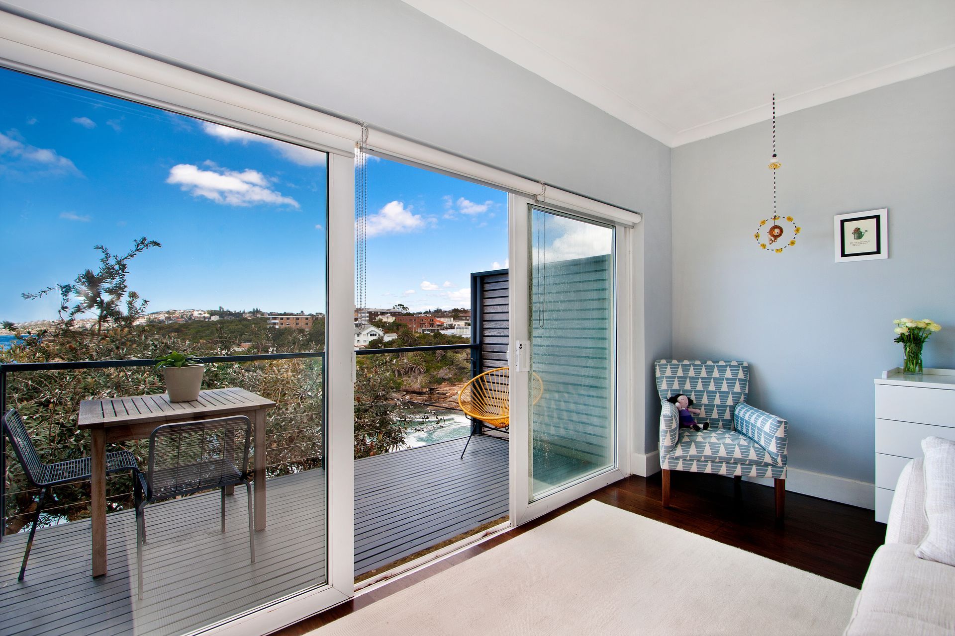 A living room with sliding glass doors leading to a balcony