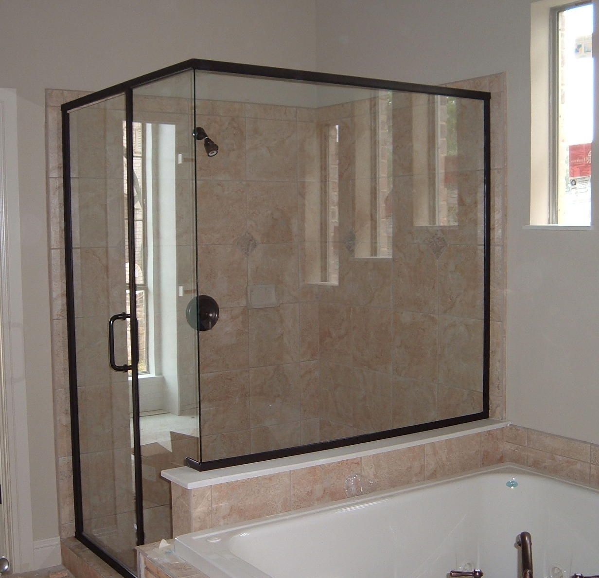 A bathroom with a bathtub and a shower stall