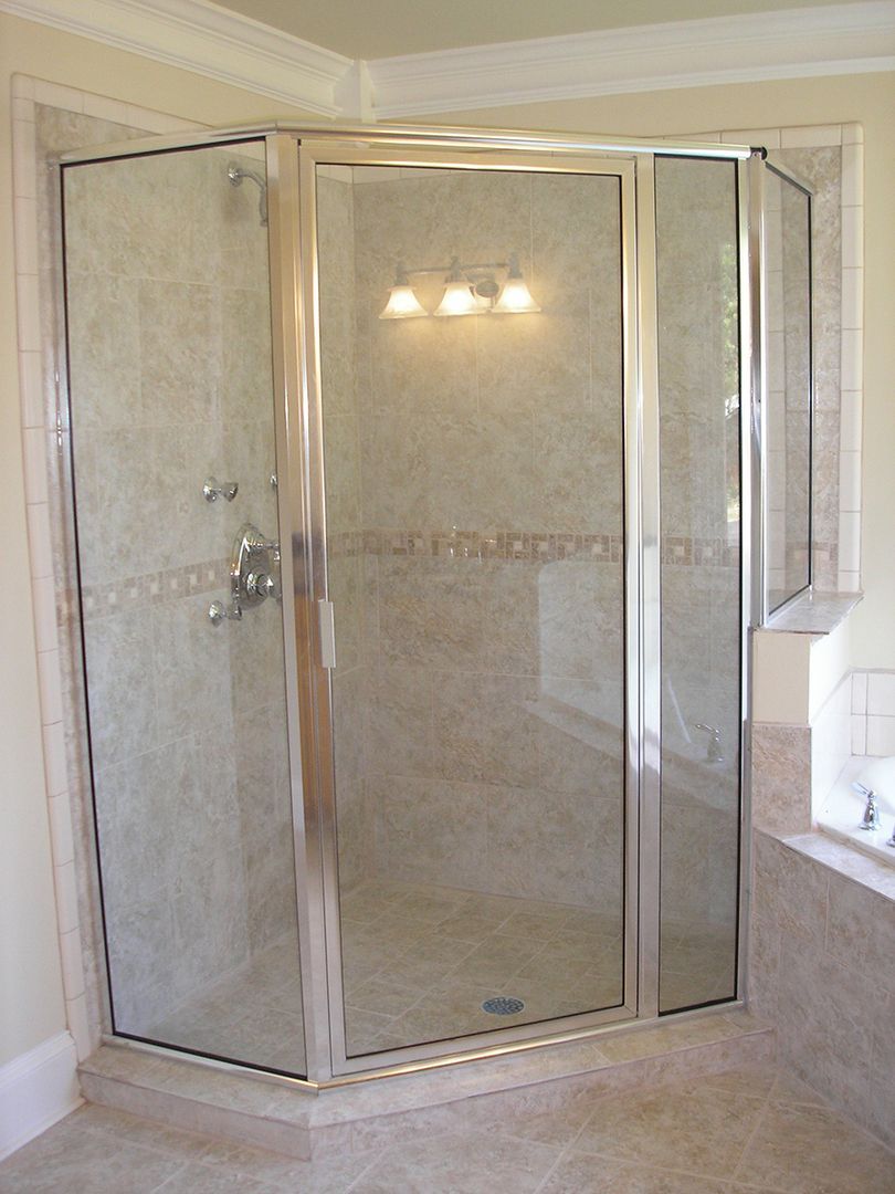 A bathroom with a walk in shower and a bathtub