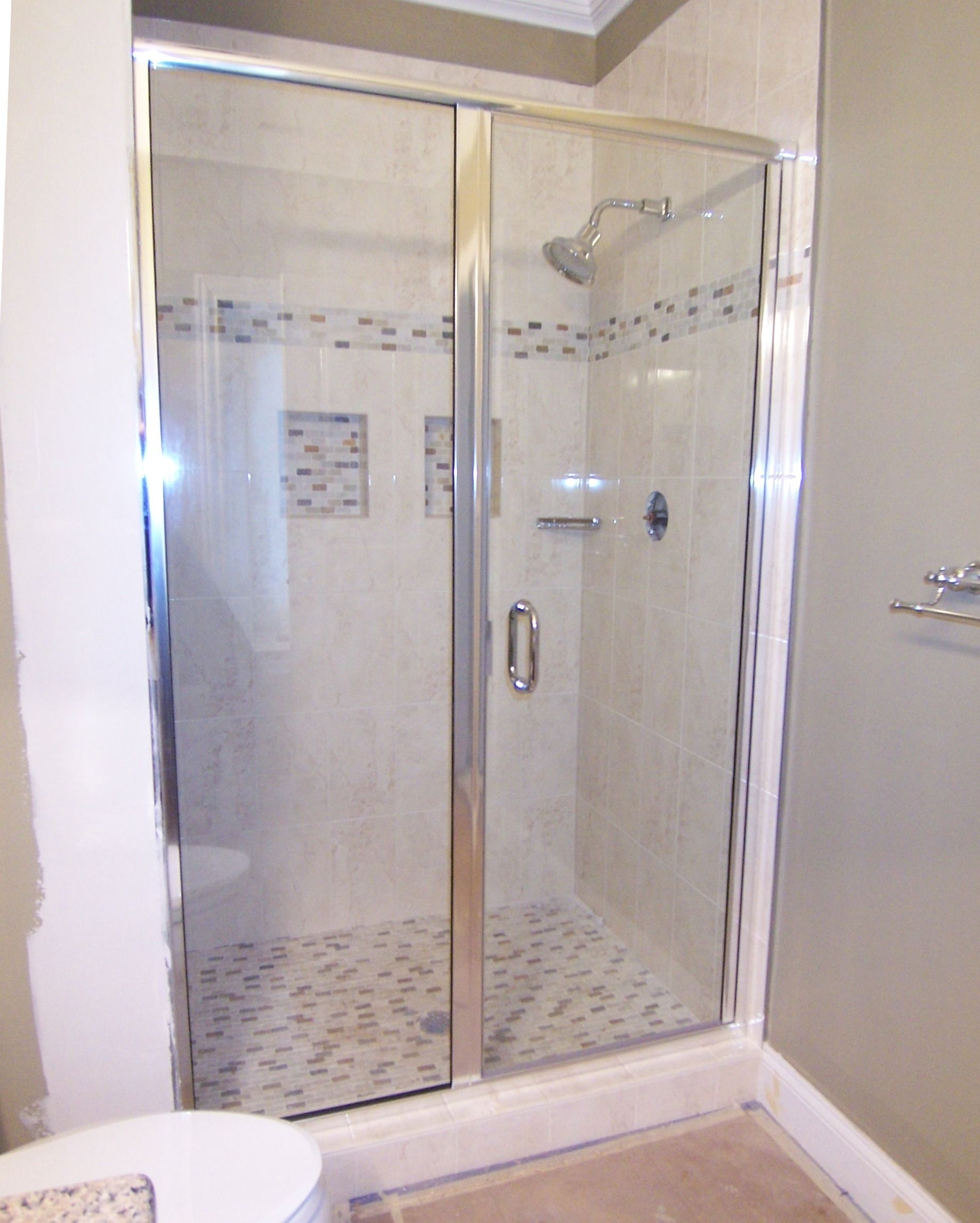 A bathroom with a walk in shower and a toilet