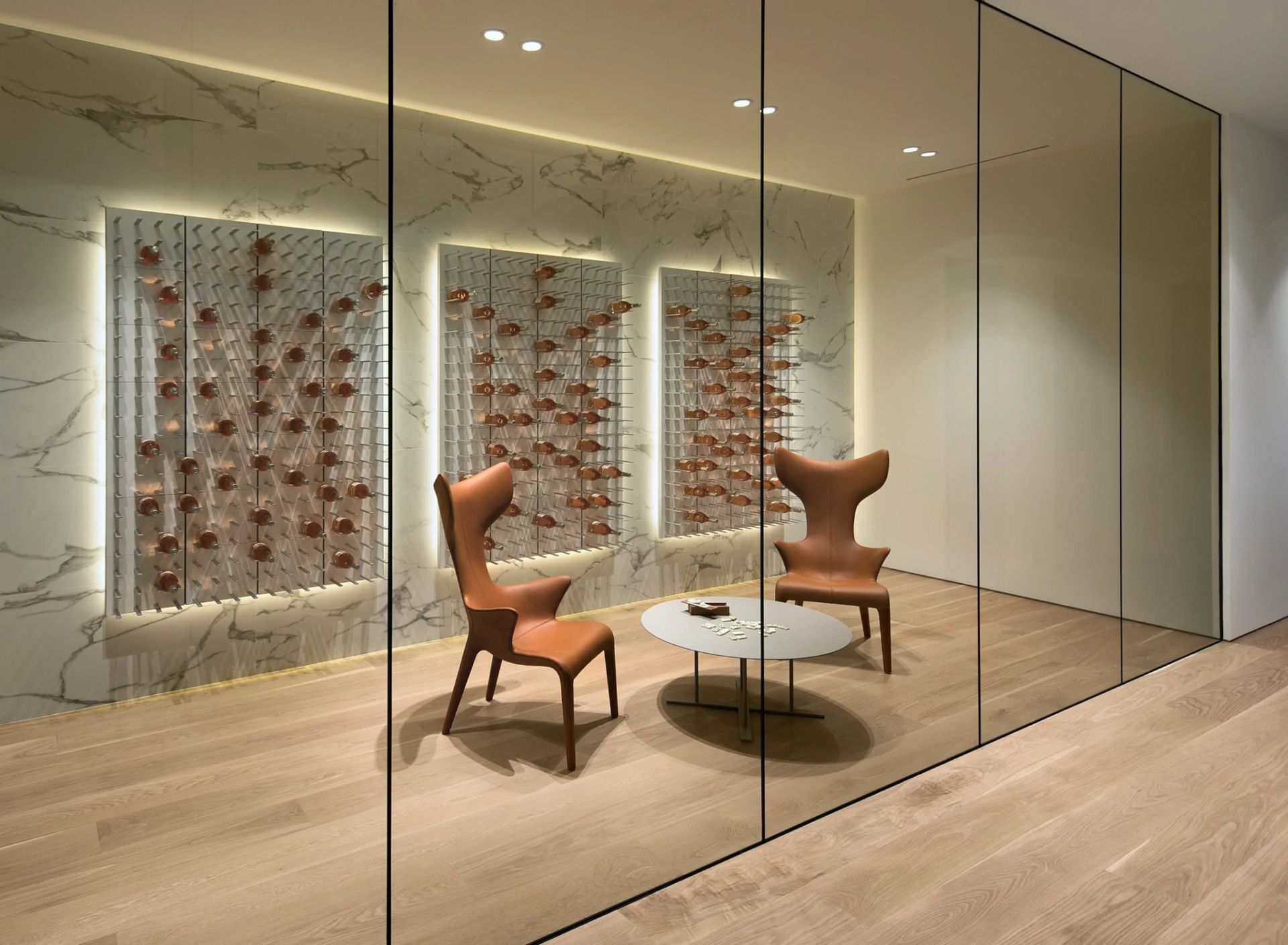 Two chairs and a table in a room with a glass wall