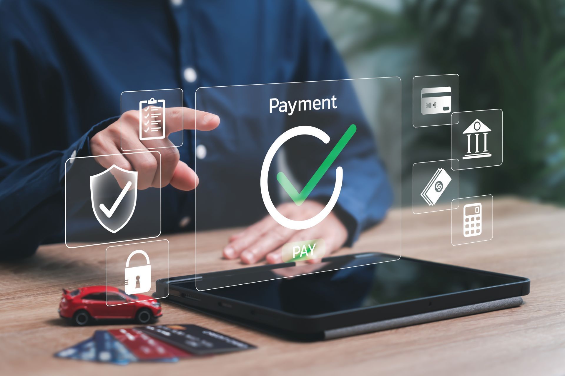 Person using a tablet to authorize payment, with digital icons of a checkmark, credit card, and car.