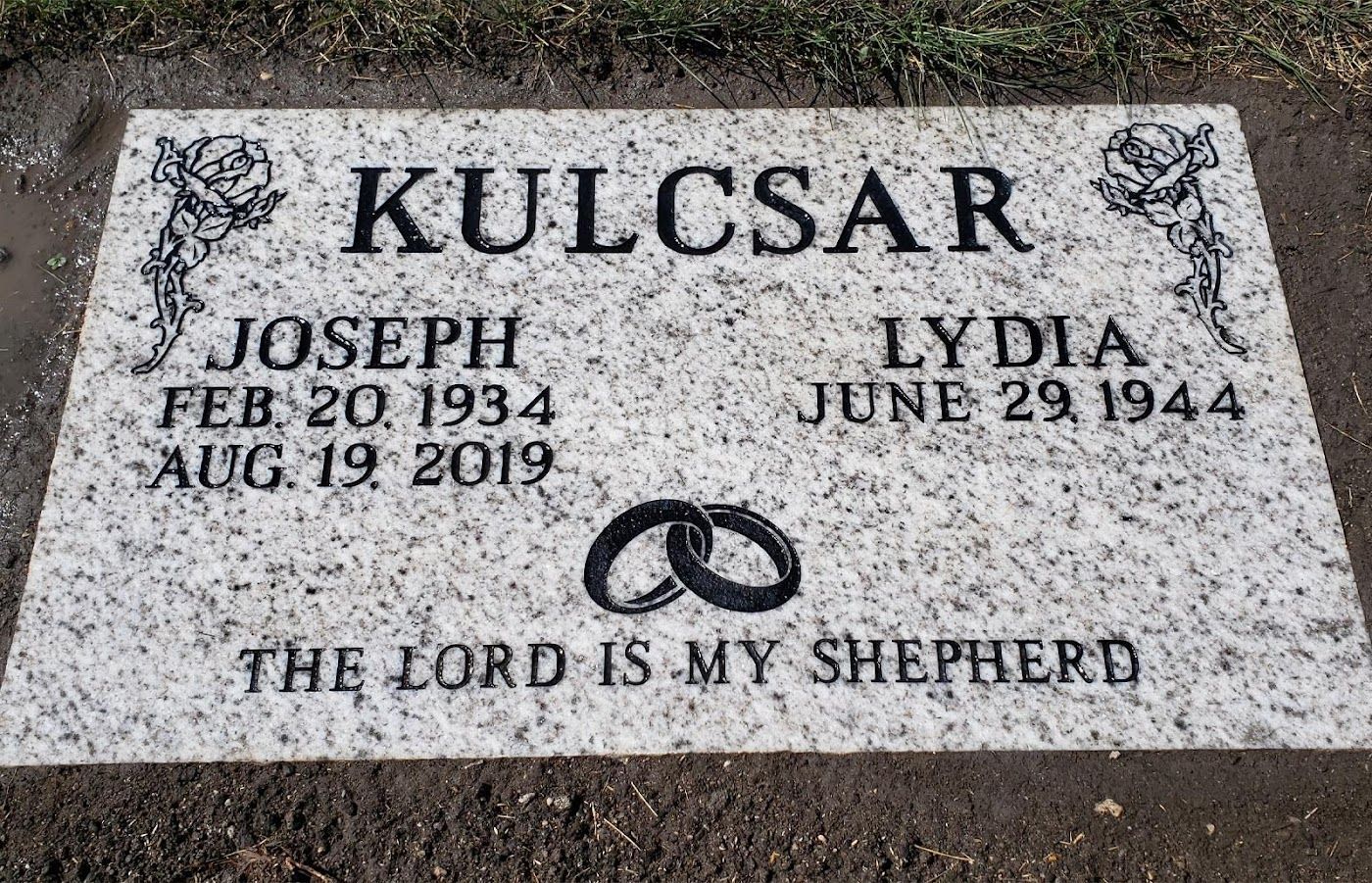 Tombstone of Joseph (1934-2019) and Lydia (1944). Features a pair of rings and the text 