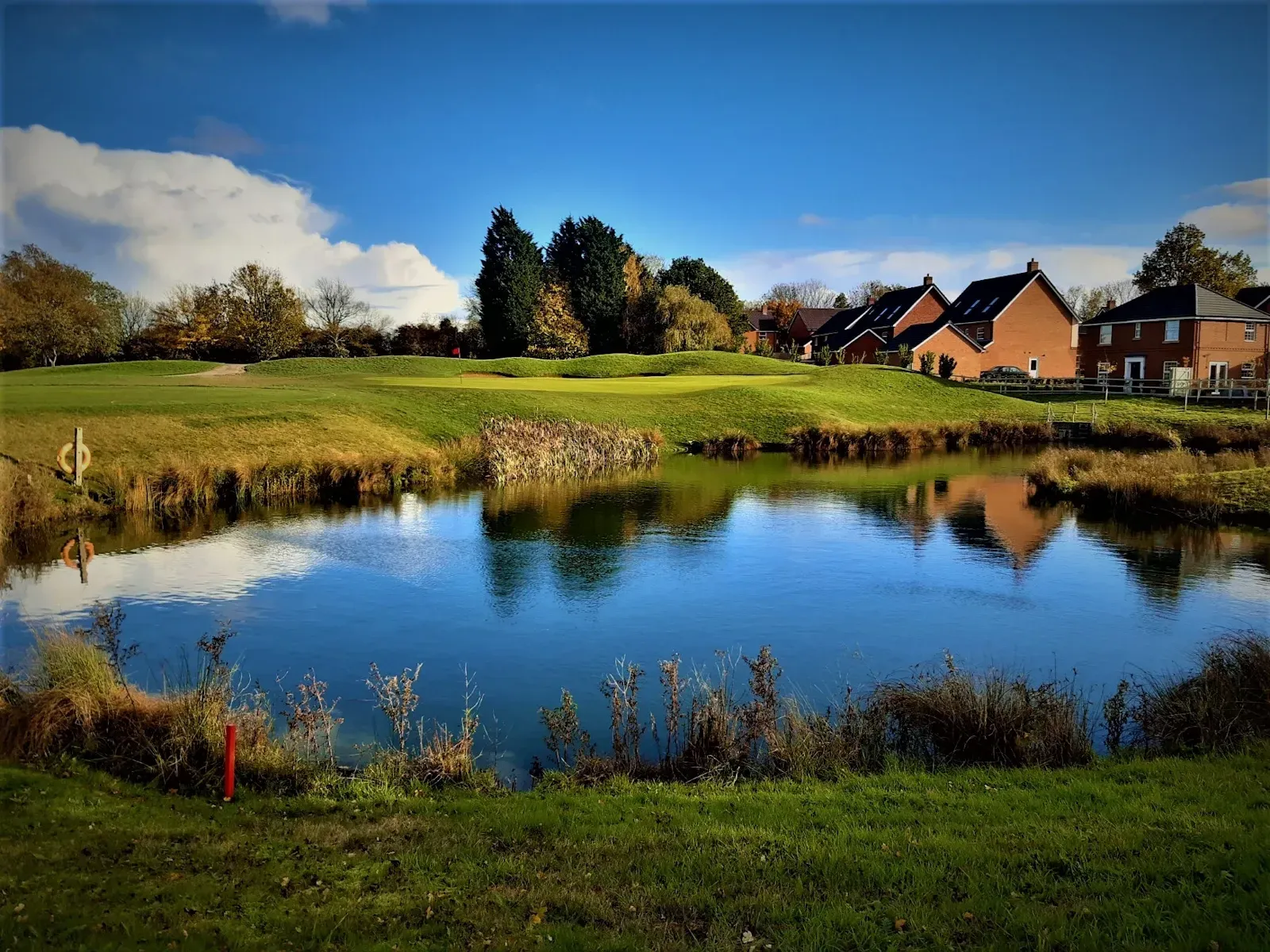 Attenuation pond on golf course with housing