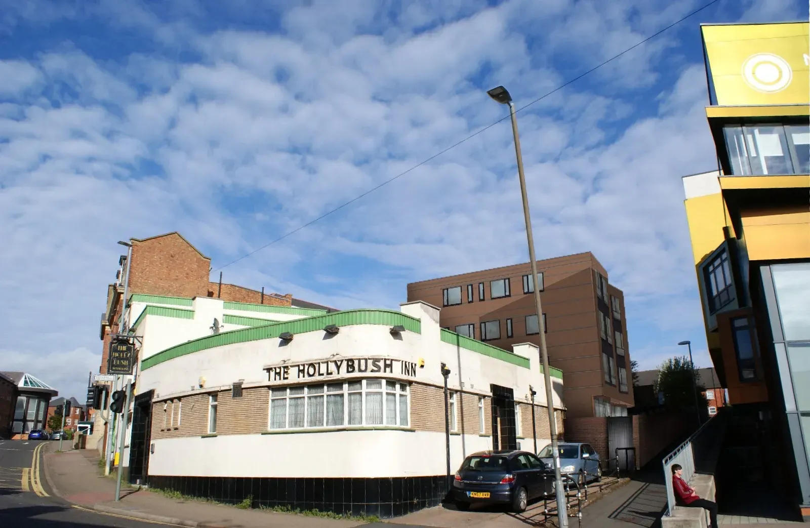 Photo of white building with new building