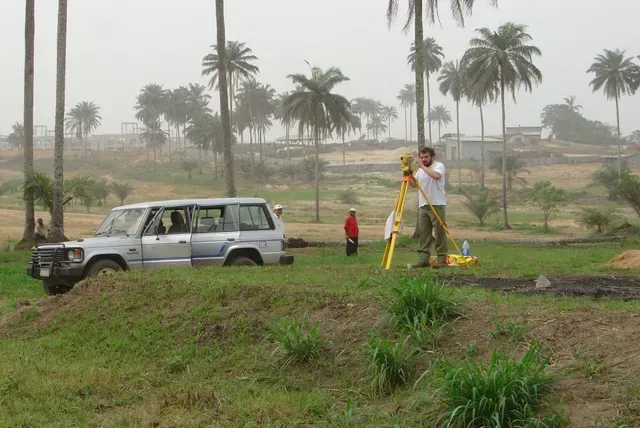 Surveyor on rasied grass area