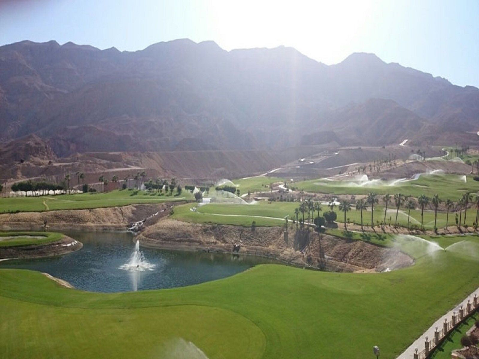 golf course with lake and fountain