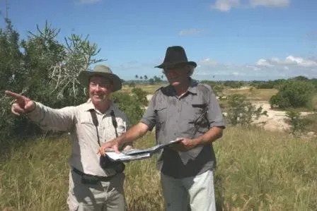 Steve with clients both looking at golf plans