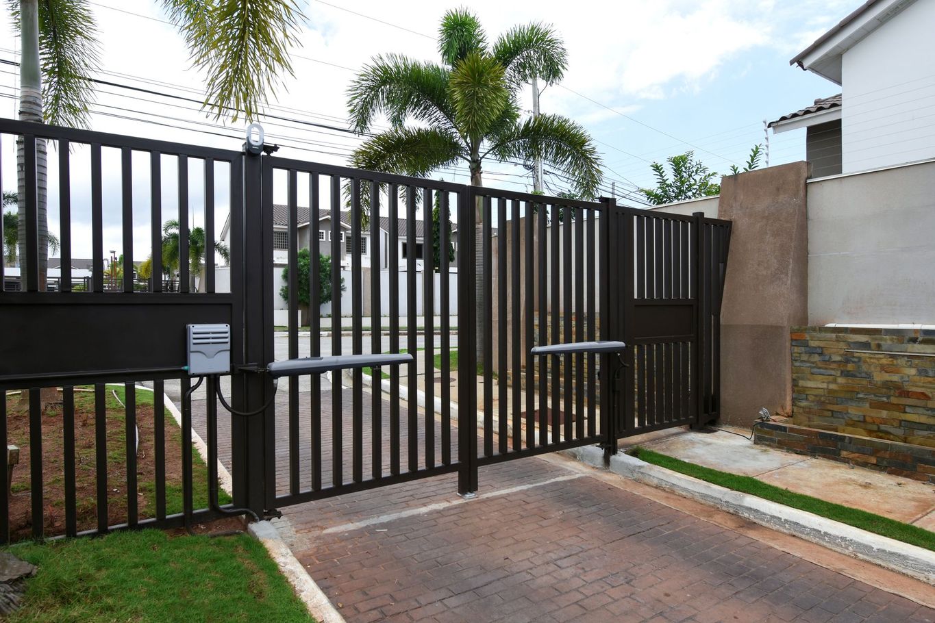 A fence with a mailbox in the middle of it