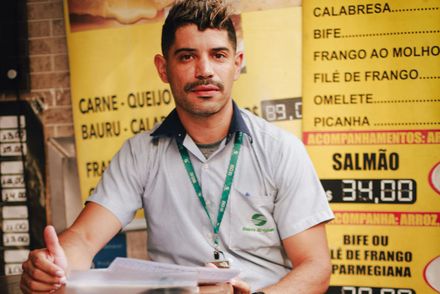 A wooden desk with a chair and a laptop on it.