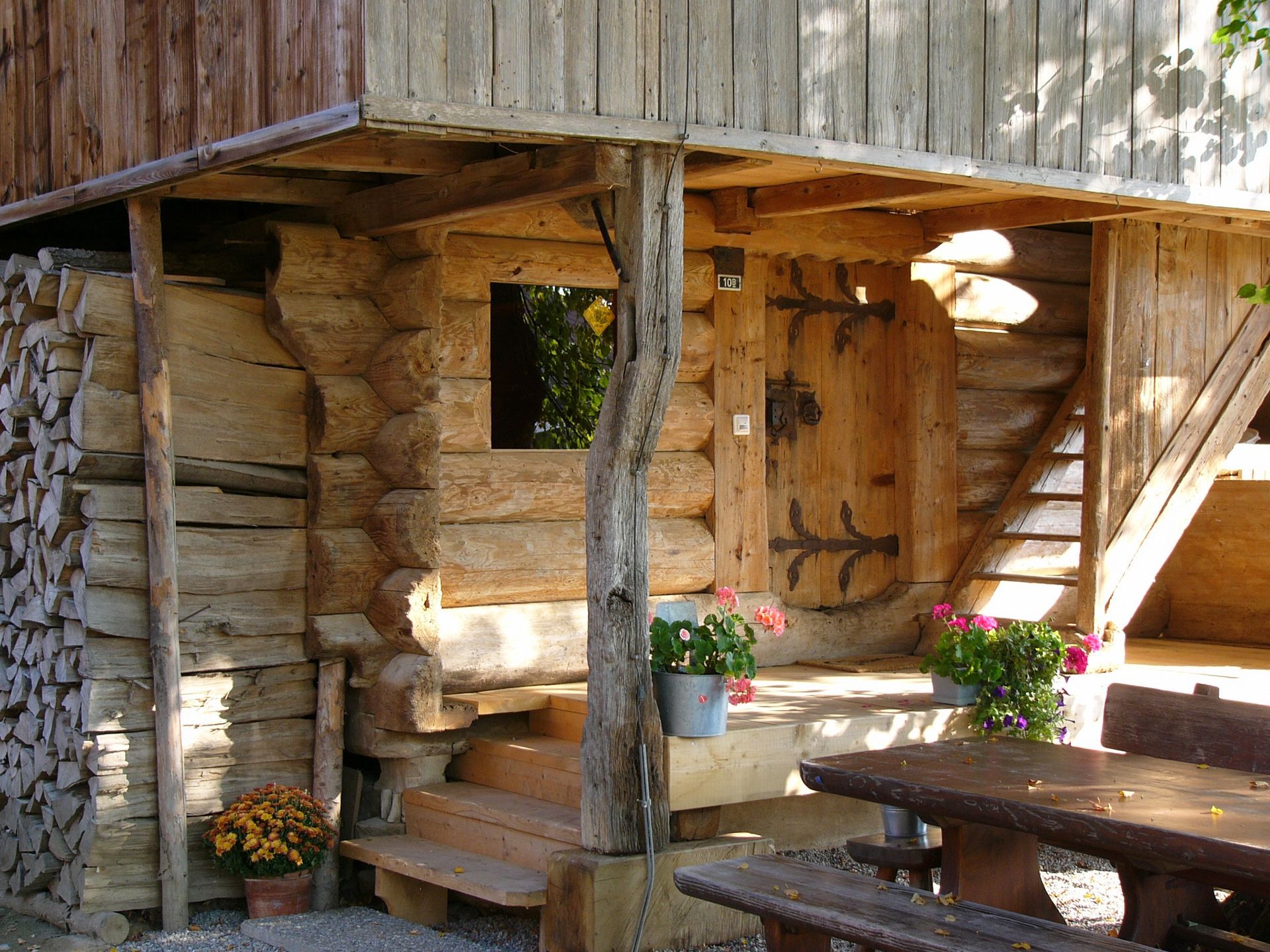 Eine Blockhütte mit einem Tisch und Bänken davor