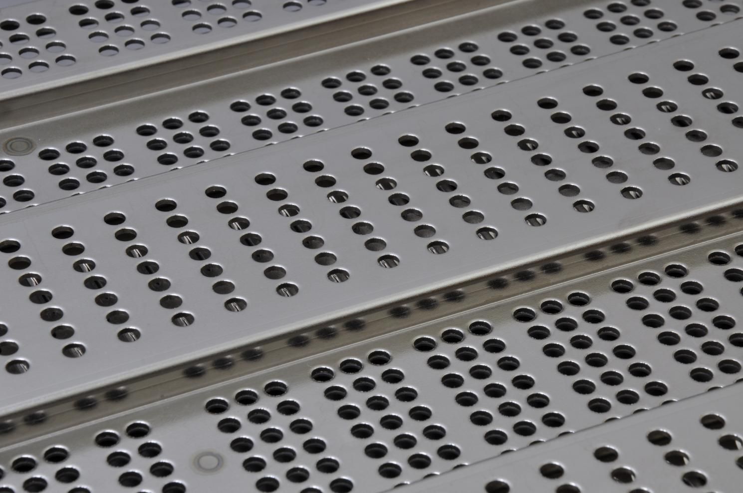 A Close up Of a Metal Grate with Holes in It — K & S Sheetmetal in Gladstone Central, QLD